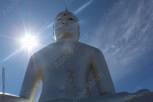 statue of woman in front of moon