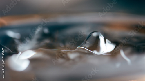 Abstract rippled background texture. Surface of water frozen in time, hi contrast lighting exposes the fascinating patterns created by soundwaves traveling directly through it. 