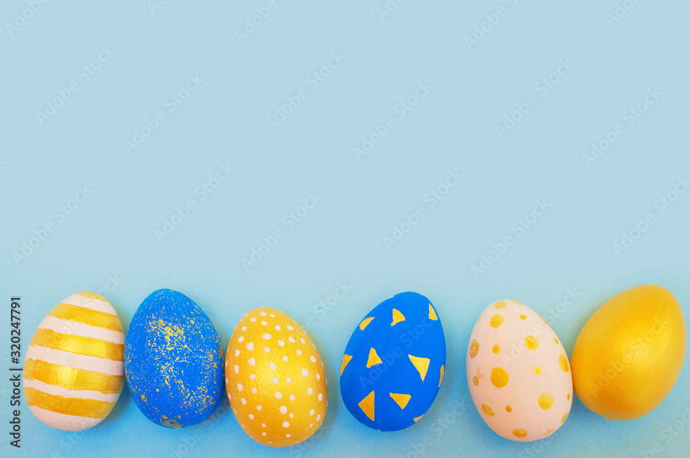 Easter golden and blue decorated eggs on blue Easter golden and blue decorated eggs on blue