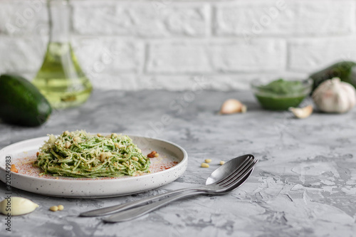 Green pasta with avocado, spinach and pine nuts