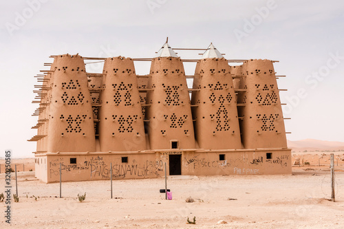 The abandoned traditional mud brick Arab dovecote in the Riyadh Province, Saudi Arabia photo