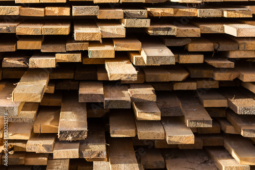 Stacked lumber background. Folded wood. Close-up cross section of board.