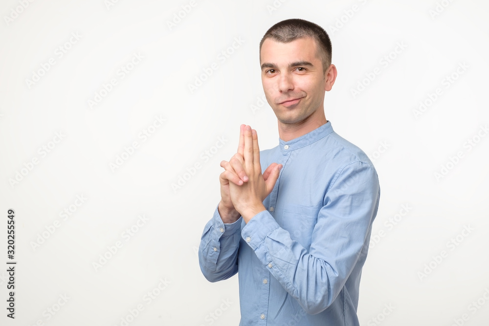 Funny young hispanic man pretending to have gun. Funny young hispanic man pretending to have gun.