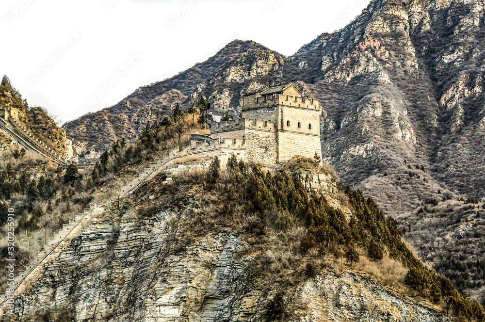 Fototapeta premium Buildings of a fragment of the Great Chinese Wall in the mountains near Bejing