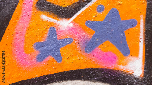 Blue stars on an orange painted wall with black waves