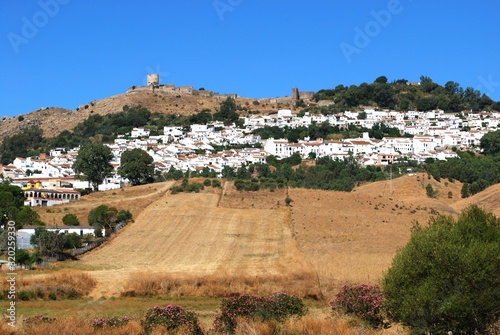 View of whitewashed village (pueblo blanco) and surrounding countryside with a castle on top of the hill, Jimena de la Frontera, Spain.