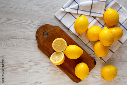 Konstfotografi Ripe Yellow Organic Lemons on a white wooden surface, overhead view
