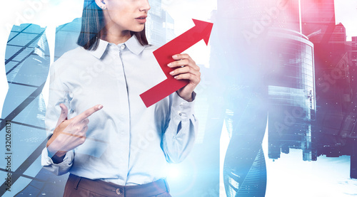 Businesswoman showing growing graph in city