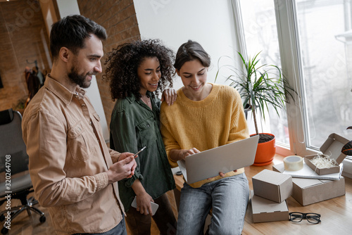 Programmers and their developer study together the details of a new project. Internet sales, e-business, e-commerce, targeting advertising, smm management, service for ordering and delivering 