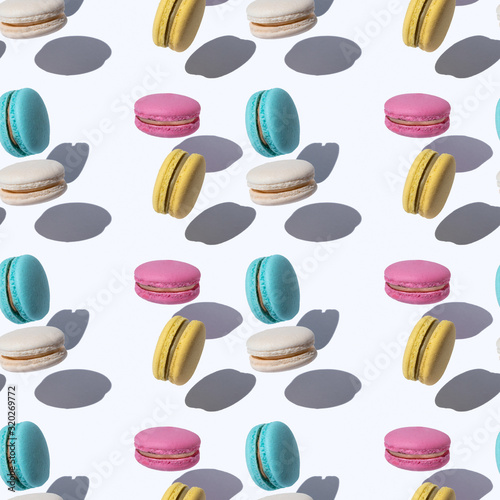 Pattern with flying macaroons in abstract style on colorful background. Magic...
