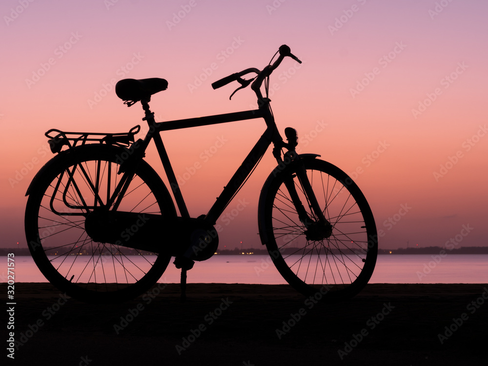 Dutch Bike in silhouette style during pink Sunset Dutch Bike in silhouette style during pink Sunset