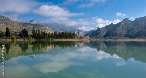 Mountains landscape reflected in the water of a reservoir