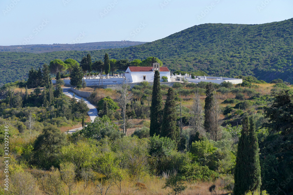 Small and picturesque church with cemetery on the rolling hills of central kythira Small and picturesque church with cemetery on the rolling hills of central kythira