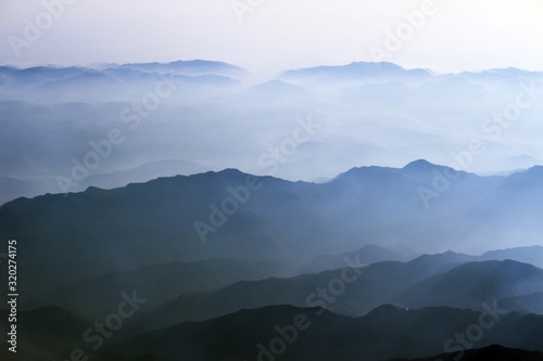 White fog over high dark green mountains range  a beautiful landscape