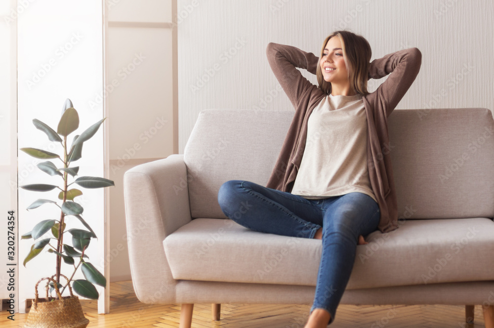 Calm girl enjoying weekends, relaxing on couch at home Calm girl enjoying weekends, relaxing on couch at home