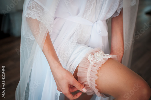 White wedding garter on the brides leg