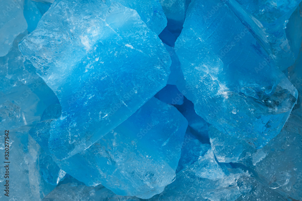 Pieces of crushed blue ice glass cracks background texture. close-up frozen water Pieces of crushed blue ice glass cracks background texture. close-up frozen water
