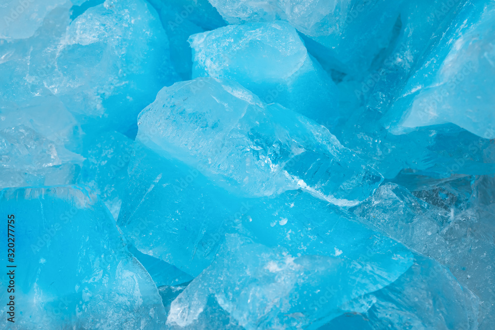 Pieces of crushed blue ice glass cracks background texture. close-up frozen water