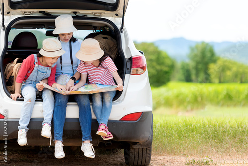 Group family children travel on car for adventure nature in vacations. Asia people tourism checking map for explore natural destination and leisure trips travel for education. Travel Concept