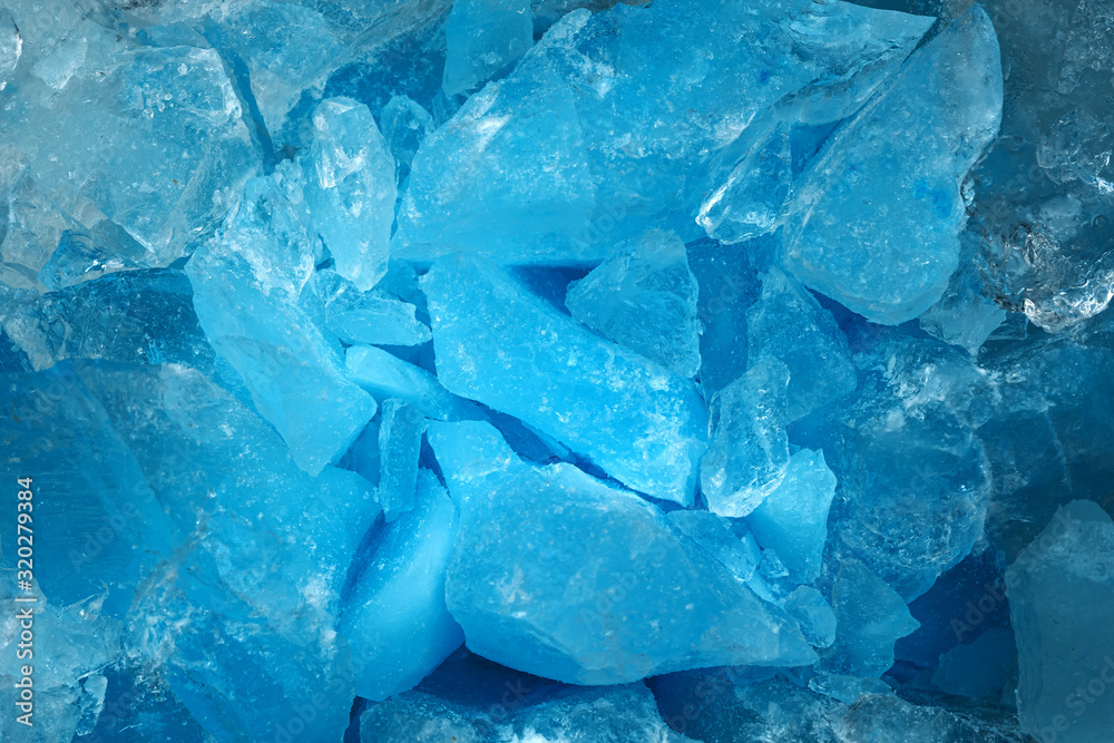 Pieces of crushed blue ice glass cracks background texture. close-up frozen water Pieces of crushed blue ice glass cracks background texture. close-up frozen water