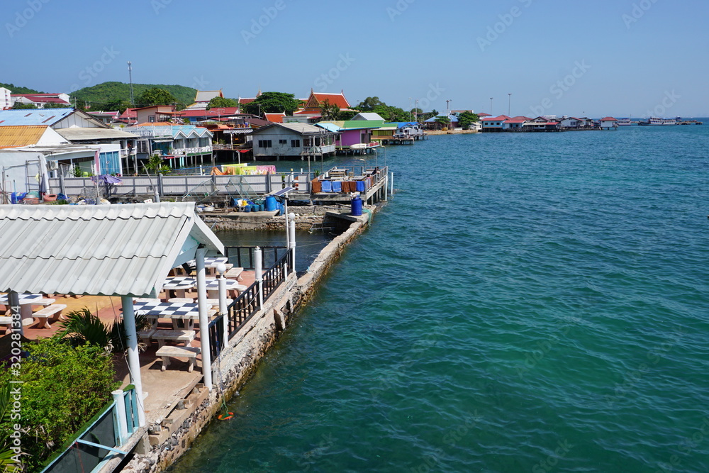 View of the sea and the coastline covered by Buildings, fisher Village on the Island Koh Larn