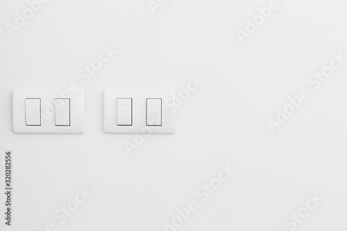 White electricity switches on white wall background