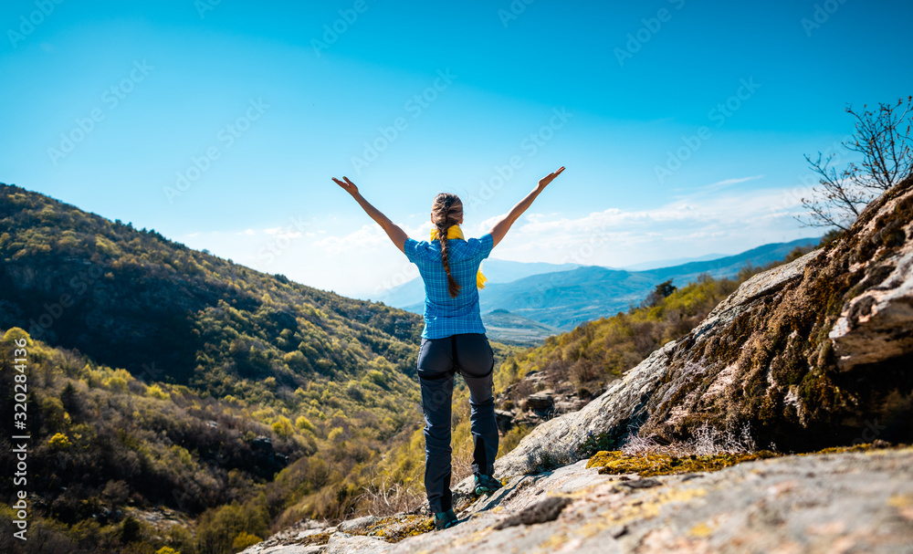Hiking woman enjoying the freedom of a mountainous landscape