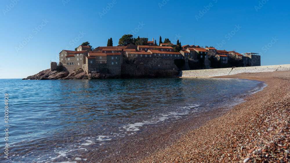 Island on the background of the Adriatic. Sveti Stefan island in Montenegro. 