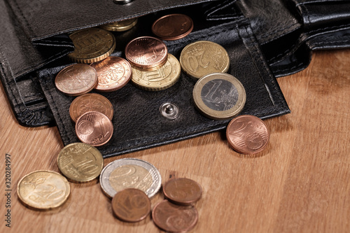 Verschiedene Euro-Münzen in einem geöffneten schwarzen Portmonnaie