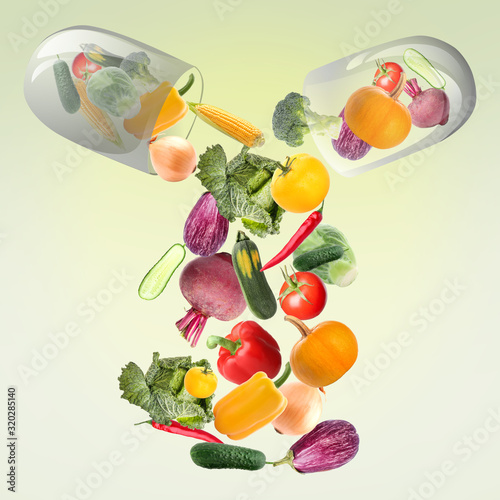 Obraz na płótnie Capsule with falling vegetables on green background