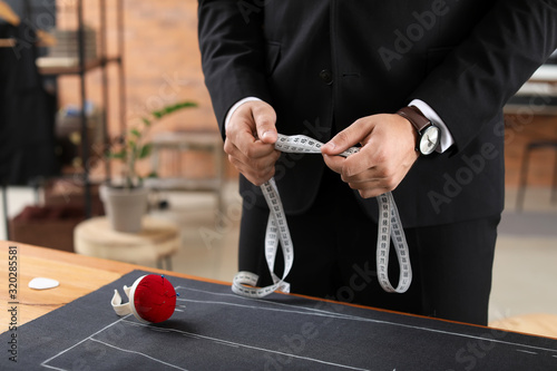 Young tailor working in ate...
