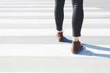Young woman crossing road. Concept of choice