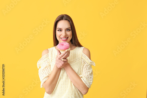 Smiling young woman holding...