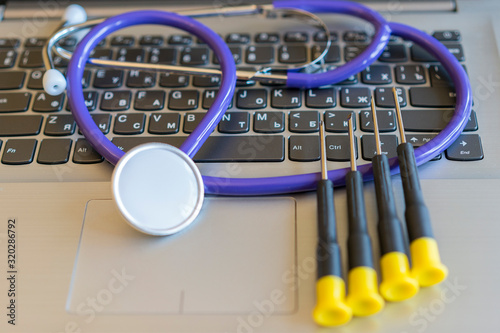 Stethoscope on laptop keyboard. Health care or IT security concept. Laptop repair concept. Computer repair concept Close-up view. Hardware. toned