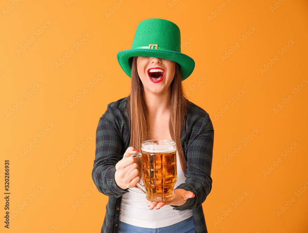 Funny young woman with beer on color background. St. Patrick's Day celebration Funny young woman with beer on color background. St. Patrick's Day celebration