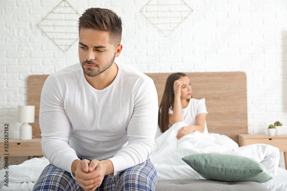 Sad couple after quarrel in bedroom Sad couple after quarrel in bedroom