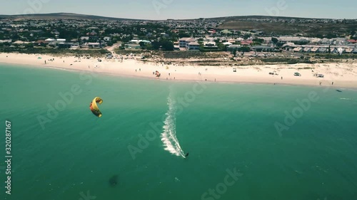 epic aerial Drone shot of Langebaan Beach, Cape Town, South Africa with paradise turquise ocean, beautiful beach and water sport kite sufing in frame. Pefrect summer vacation and holiday. photo