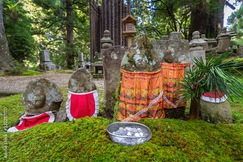 Jizo Statue in Ancient Graveyard of Okunoin Cemetery, Koyasan, Japan. photo