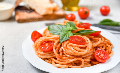 pasta spaghetti with tomatoes and basil.  traditional dish of Italian cuisine. pasta recipe