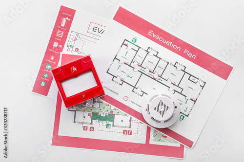 Photo Evacuation plans, smoke detector and manual call point on white background
