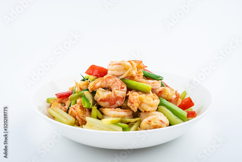 Stir-fried shrimp with celery in a dish on white background