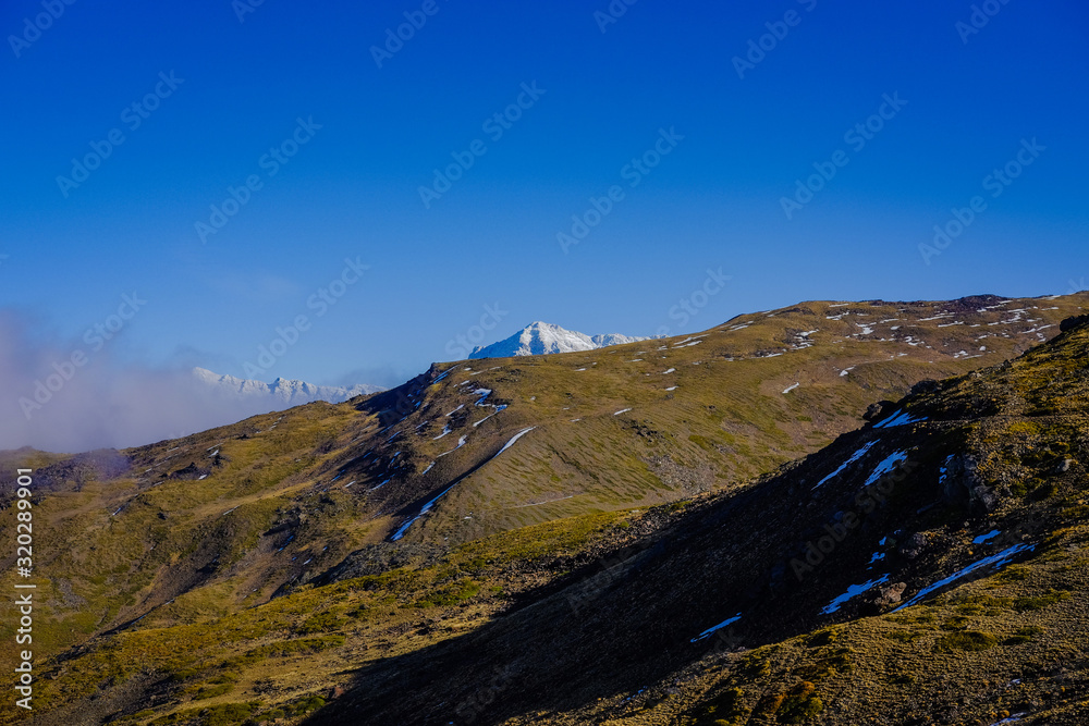 Beautiful landscape snow covered mountains and blue sky