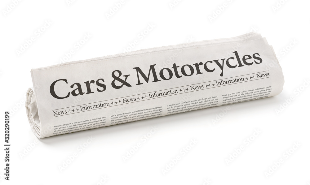 Obraz premium Rolled newspaper with the headline Cars and Motorcycles