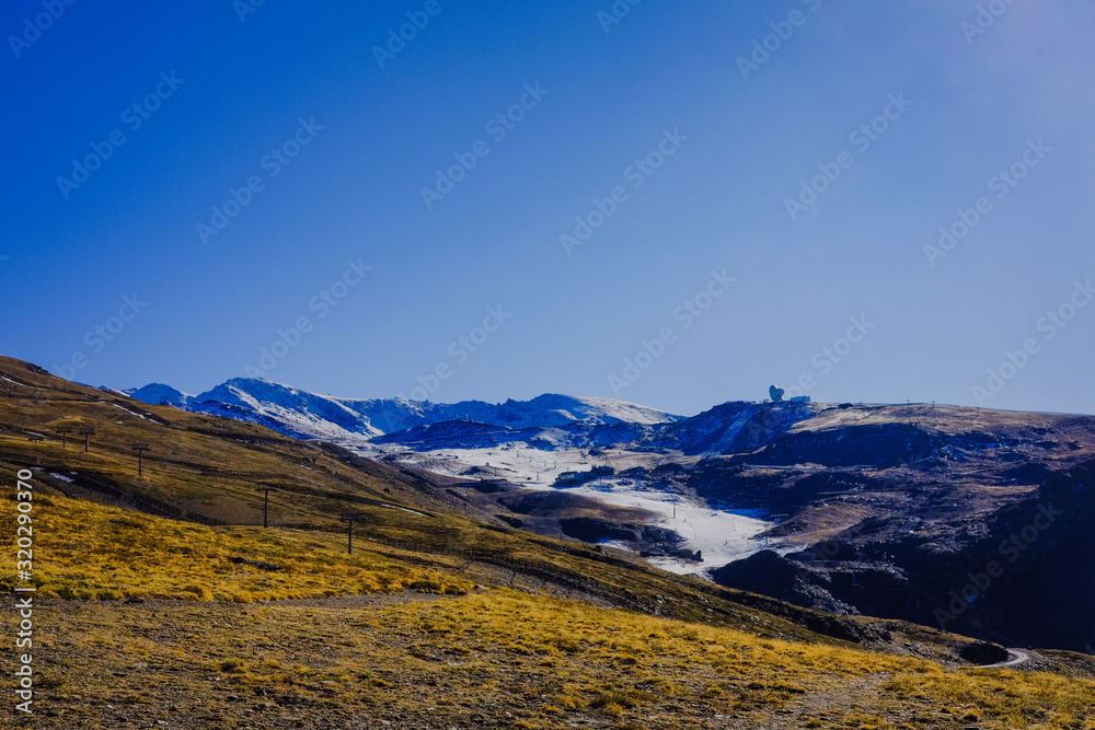 Beautiful landscape snow covered mountains and blue sky