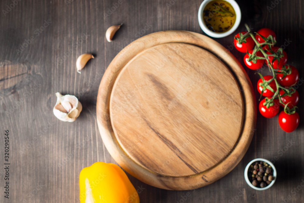 Wooden Cutting Board with Fresh Herbs and Raw Vegetables on Rustic Wood Table. Top view. Cooking background. Wooden Cutting Board with Fresh Herbs and Raw Vegetables on Rustic Wood Table. Top view. Cooking background.