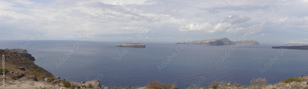 Panoramic views of the caldera, mountains, the Mediterranean Sea, and the city of Fira from the Akrotiri Lighthouse.