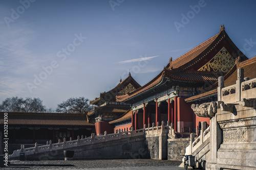 Forbidden City in Beijing. View of a traditional Prayer Hall in red wall and columns and typical roof ornaments.