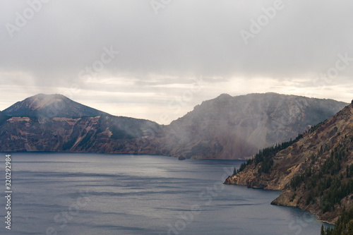 A storm cloud discharging water over Crater Lake