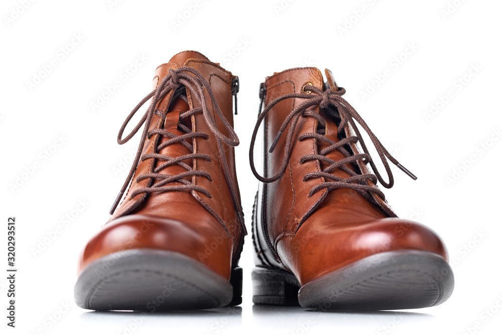 Pair of brown leather womens boots on the white background isolated