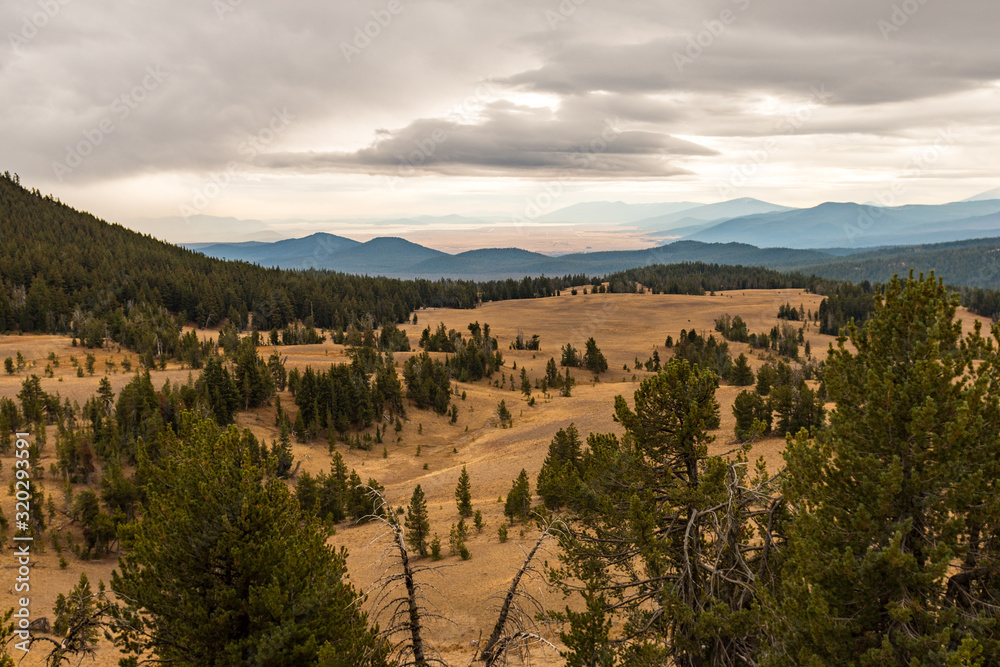 Naklejka premium Plain among the mountains one stormy day seen from Crater Lake